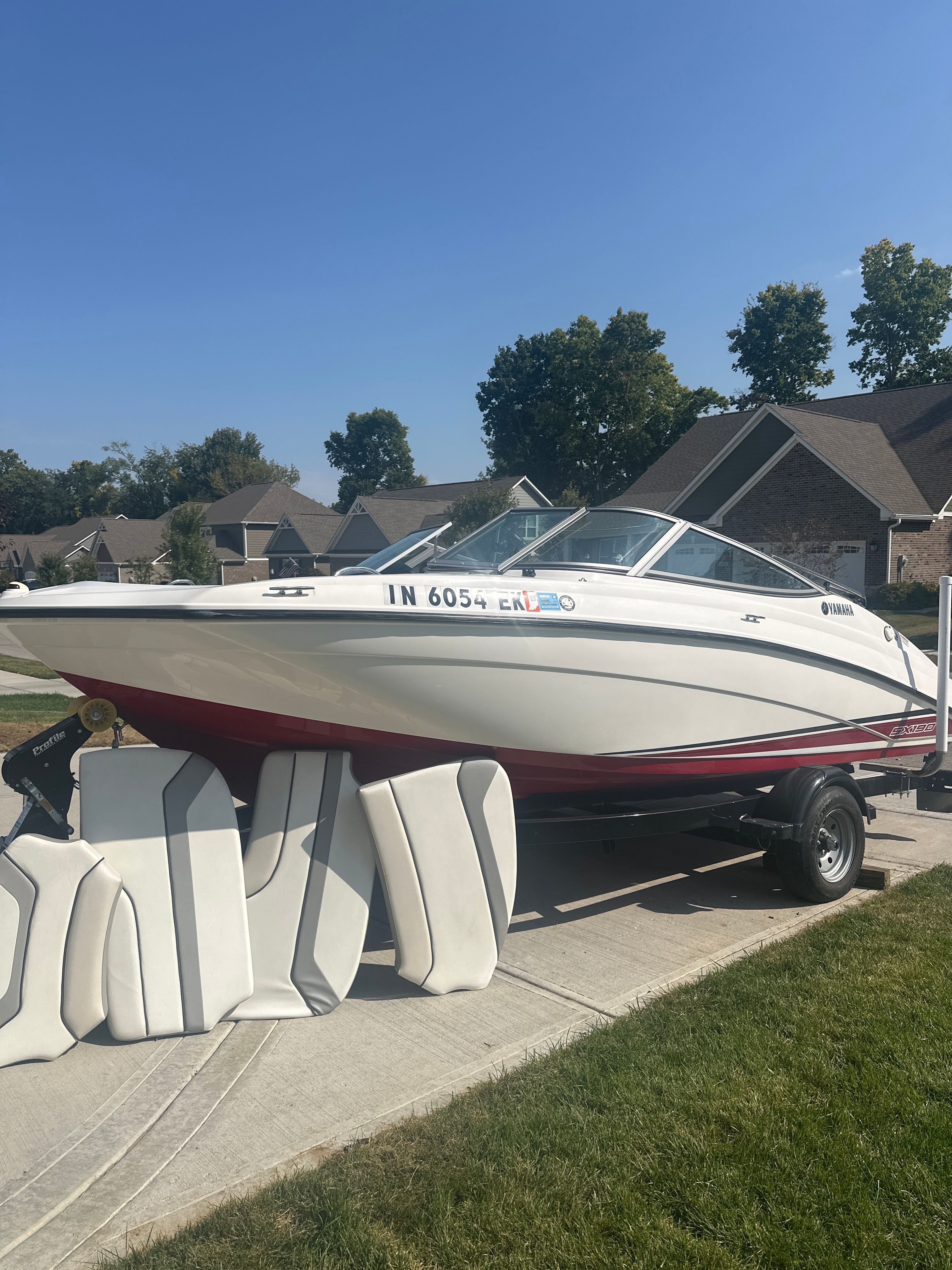 Yamaha Boats SX190 2018 Yamaha Boats SX190 on trailer with seat cushions, parked in residential area.