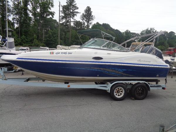 Hurricane SunDeck 217 OB 2011 Hurricane SunDeck 217 OB boat on a trailer in a parking lot.