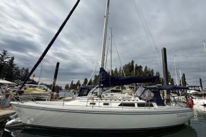 Catalina MK 1.5 1990 Catalina MK 1.5 sailboat docked at marina under cloudy sky.