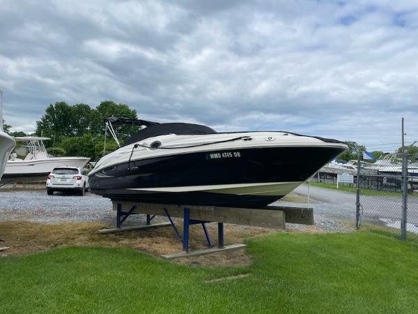 Sea Ray 240 Sundeck 2005 Sea Ray 240 Sundeck boat on a stand in a marina.