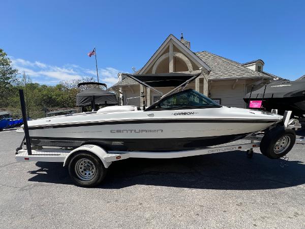 Centurion Carbon Pro 2016 Centurion Carbon Pro boat on trailer, parked outdoors near a house.