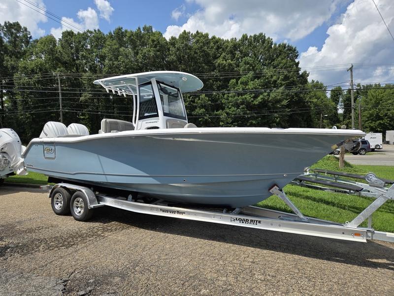 Sea Hunt Ultra 275se 2026 Sea Hunt Ultra 275se boat on trailer, parked outdoors under a cloudy sky.