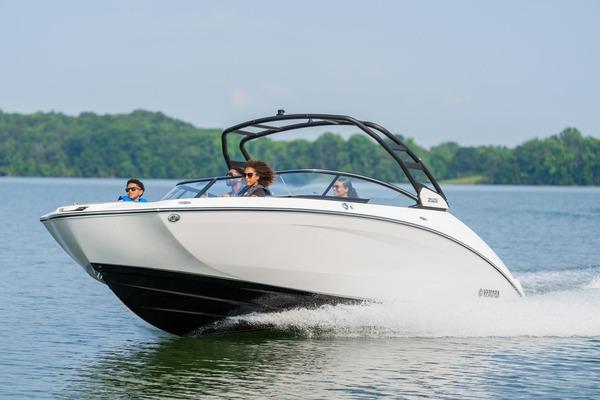 Yamaha Boats 252S 2026 Yamaha Boats 252S cruising on a lake with passengers, showcasing sleek design and performance.