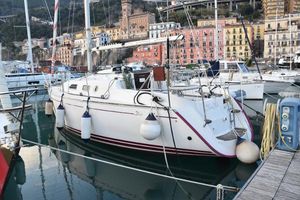 Delphia 29 Delphia 29' 2007 sailboat docked in a colorful marina setting.