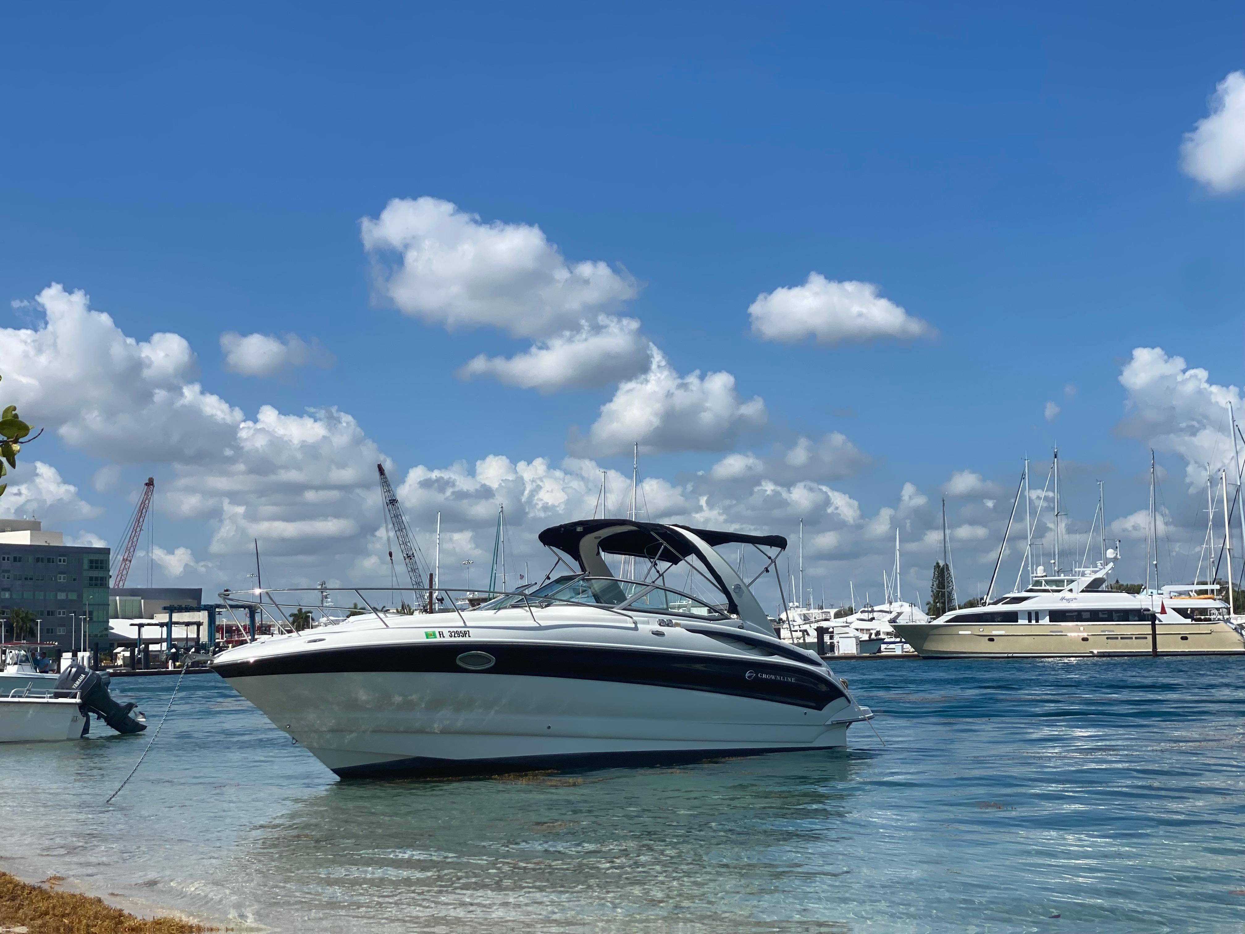 Crownline 270 CR 2006 Crownline 270 CR boat docked in a sunny marina with blue skies.