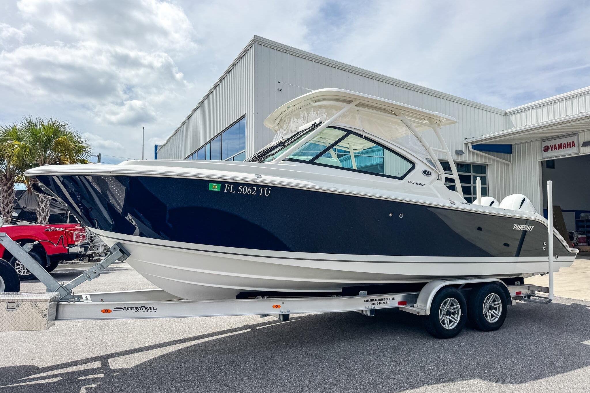 Pursuit DC 266 Dual Console 2023 Pursuit DC 266 Dual Console boat on trailer outside dealership.