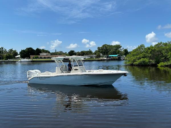 Key West 291 FS 2025 Key West 291 FS boat cruising on a calm lake under a clear blue sky.