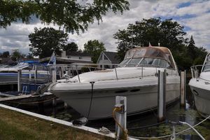 Sea Ray 340 Sundancer 1999 Sea Ray 340 Sundancer docked at marina, surrounded by trees and other boats.