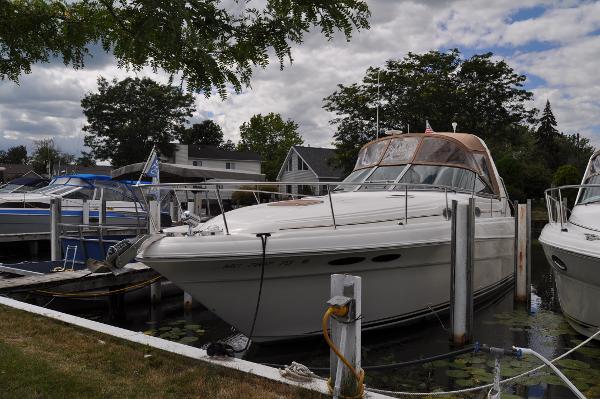 Sea Ray 340 Sundancer 1999 Sea Ray 340 Sundancer docked at marina, surrounded by trees and other boats.