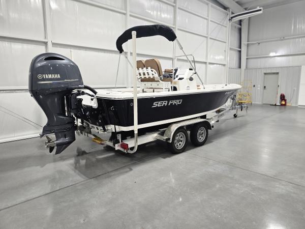 Sea Pro 208 Bay 2023 Sea Pro 208 Bay boat with Yamaha engine in a garage.