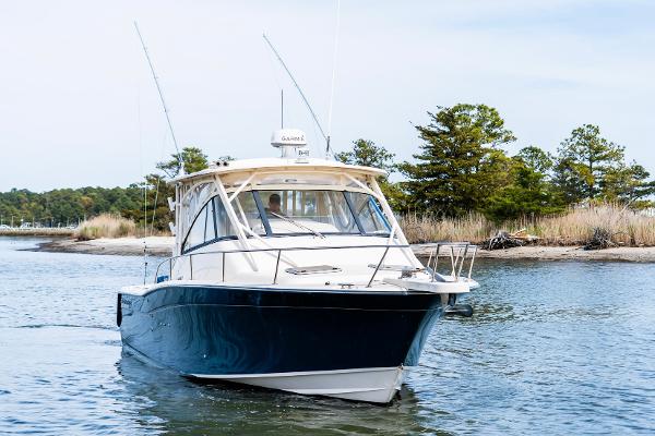 Grady-White Express 330 2015 Grady-White 330 Express boat cruising on a serene waterway.