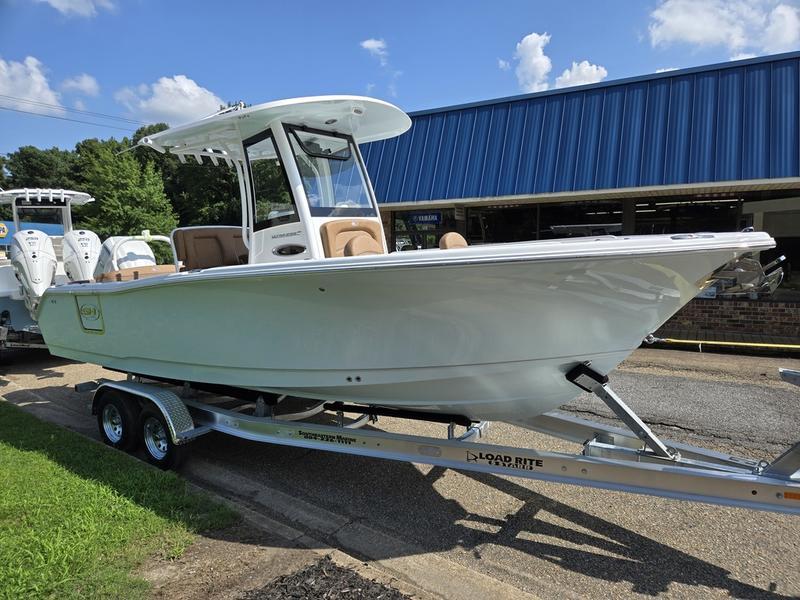 Sea Hunt Ultra 255se 2026 Sea Hunt Ultra 255se boat on trailer, parked outdoors under blue sky.