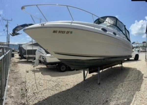 Sea Ray 260 Sundancer 2001 Sea Ray 260 Sundancer boat on dry dock under clear blue sky.