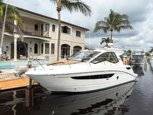 Sea Ray Sundancer 350 Coupe 2019 Sea Ray Sundancer 350 Coupe docked by a luxurious waterfront home.