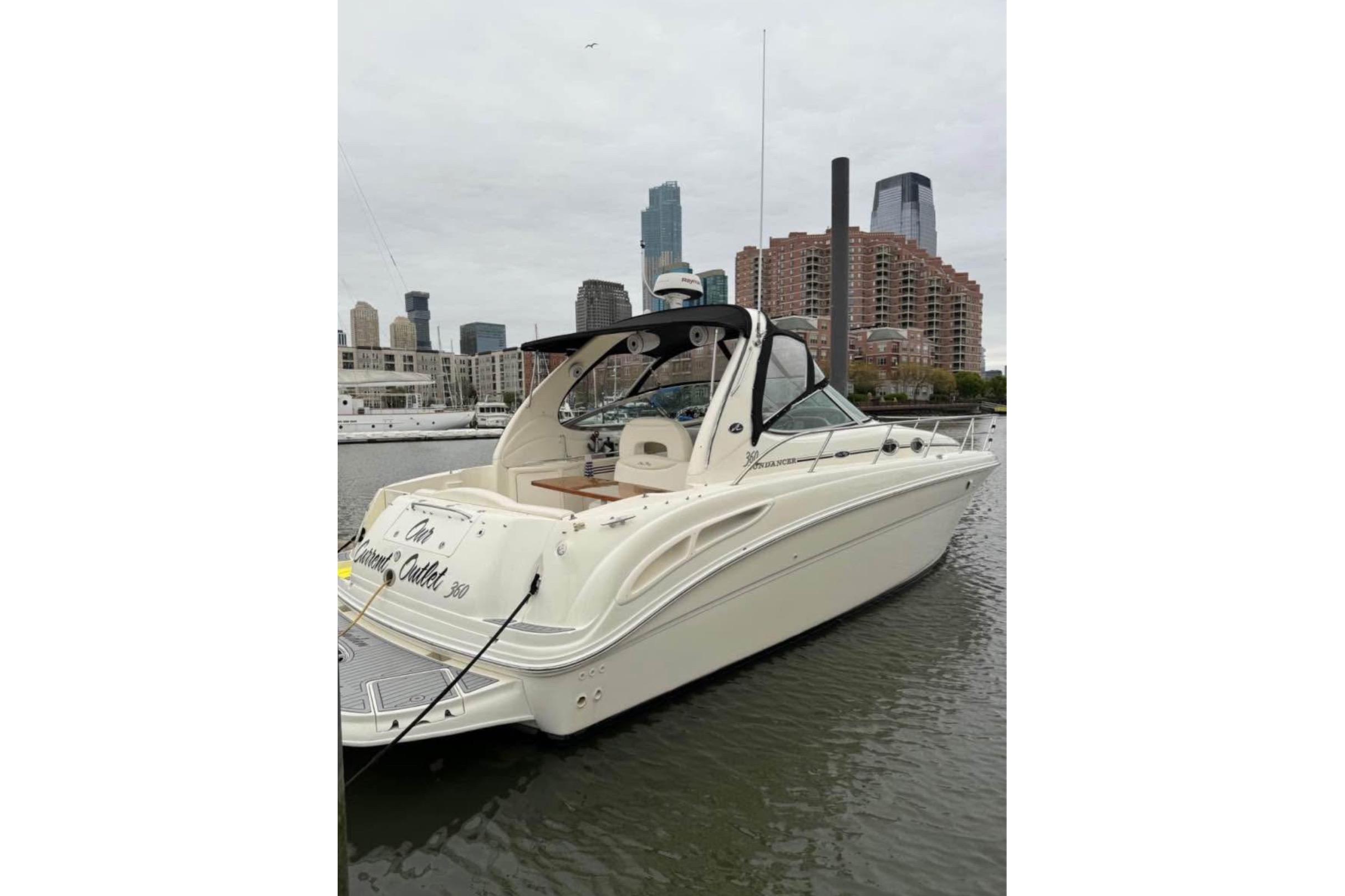 Sea Ray 360 Sundancer 2003 Sea Ray 360 Sundancer yacht docked in urban marina with city skyline.