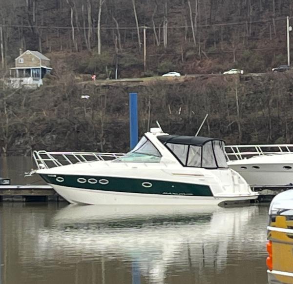 Maxum 3100 SE 2009 Maxum 3100 SE boat docked on a calm river with wooded background.
