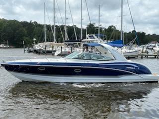 Formula 350 Sun Sport 2012 Formula 350 Sun Sport boat on water, surrounded by sailboats and trees.