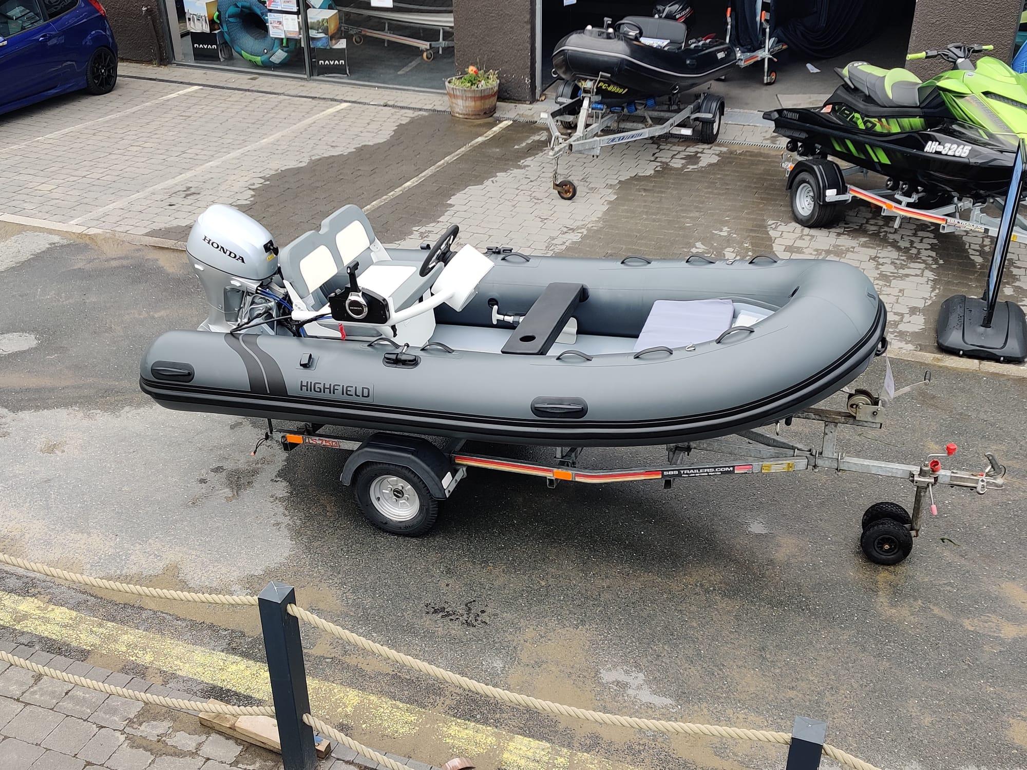 Highfield Classic 380 2019 Highfield Classic 380 inflatable boat on trailer, equipped with Honda outboard motor.