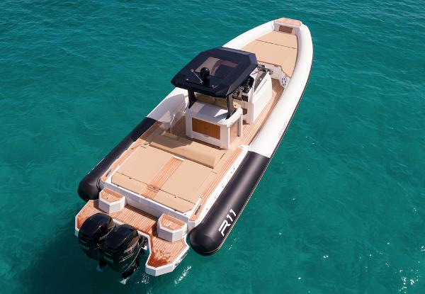 Renier R11 FB 2024 Renier R11 FB boat on clear turquoise water, featuring dual outboard motors.