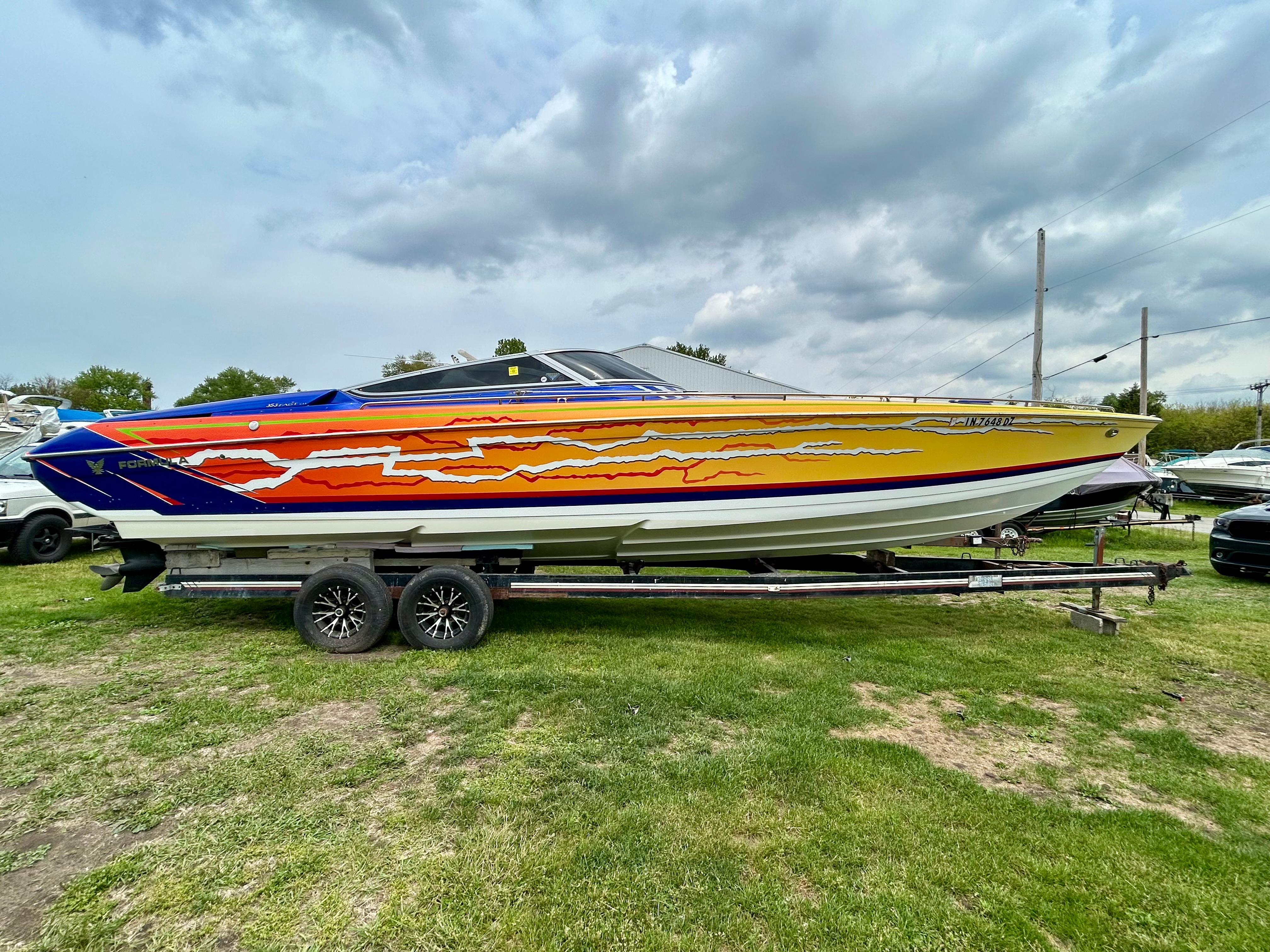 Formula 353 FASTech 2008 Formula 353 FASTech boat with vibrant, colorful graphics on a trailer.