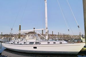 Passport 470 Center Cockpit 2013 Passport 470 Center Cockpit sailboat docked at marina under clear blue sky.