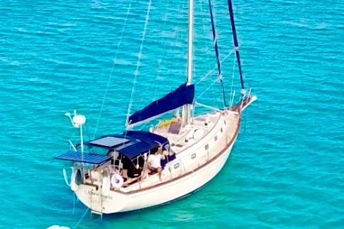 Island Packet 40 1995 Island Packet 40 sailboat on clear turquoise water.