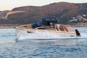 Nuva M11 cabin 2025 Nuva M11 cabin boat cruising on calm waters near a mountainous coastline.