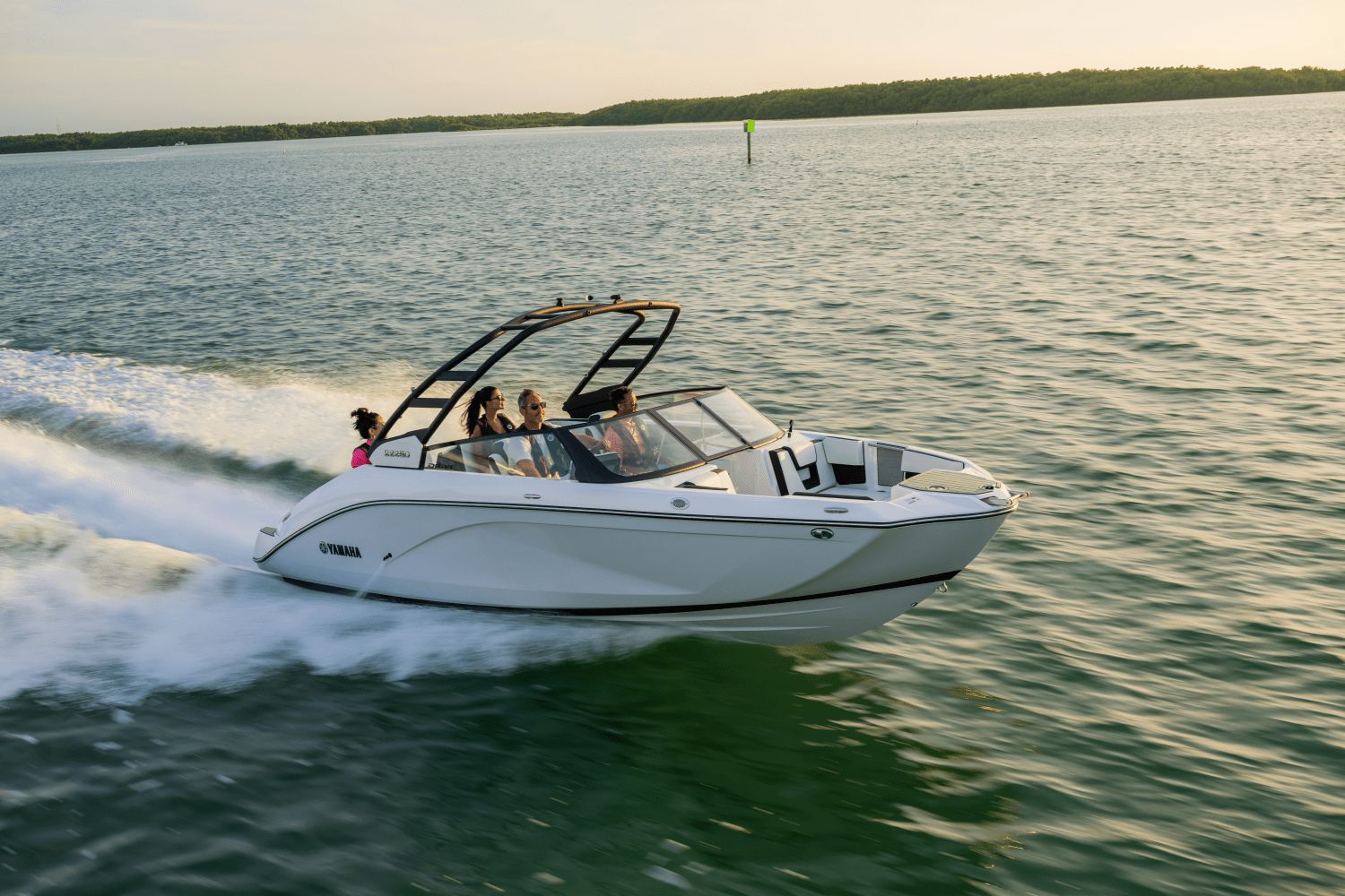 Yamaha Boats 222SD 2024 Yamaha Boats 222SD cruising on open water at sunset.