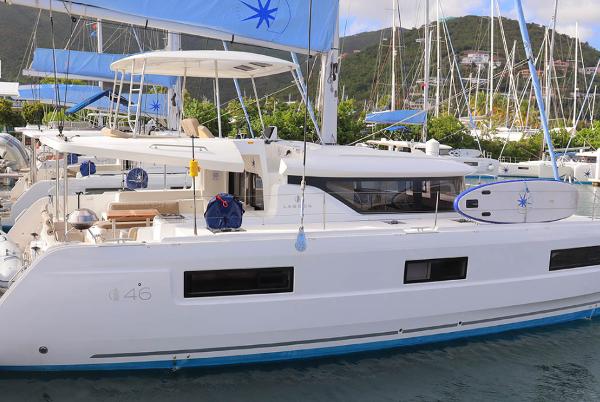 Lagoon 46 2023 Lagoon 46 catamaran docked in a marina, featuring sleek design and modern amenities.