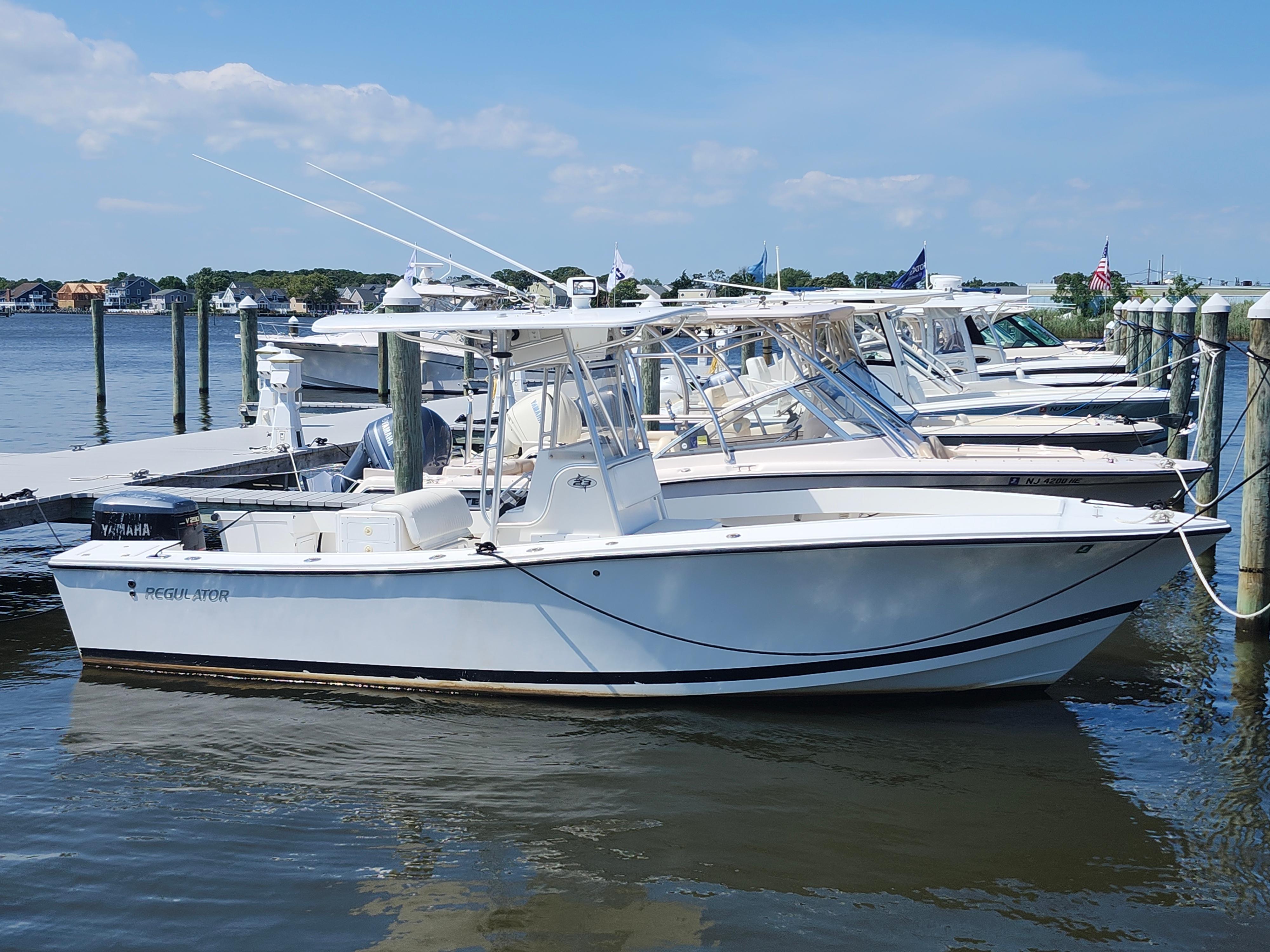 Regulator 23 Classic 2002 Regulator 23 Classic boat docked at marina, clear sky, calm water.