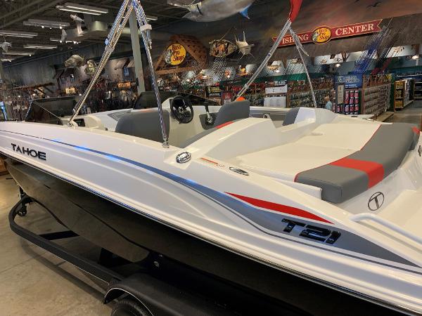 Tahoe T21 2024 Tahoe T21 boat displayed in a showroom with fishing gear.