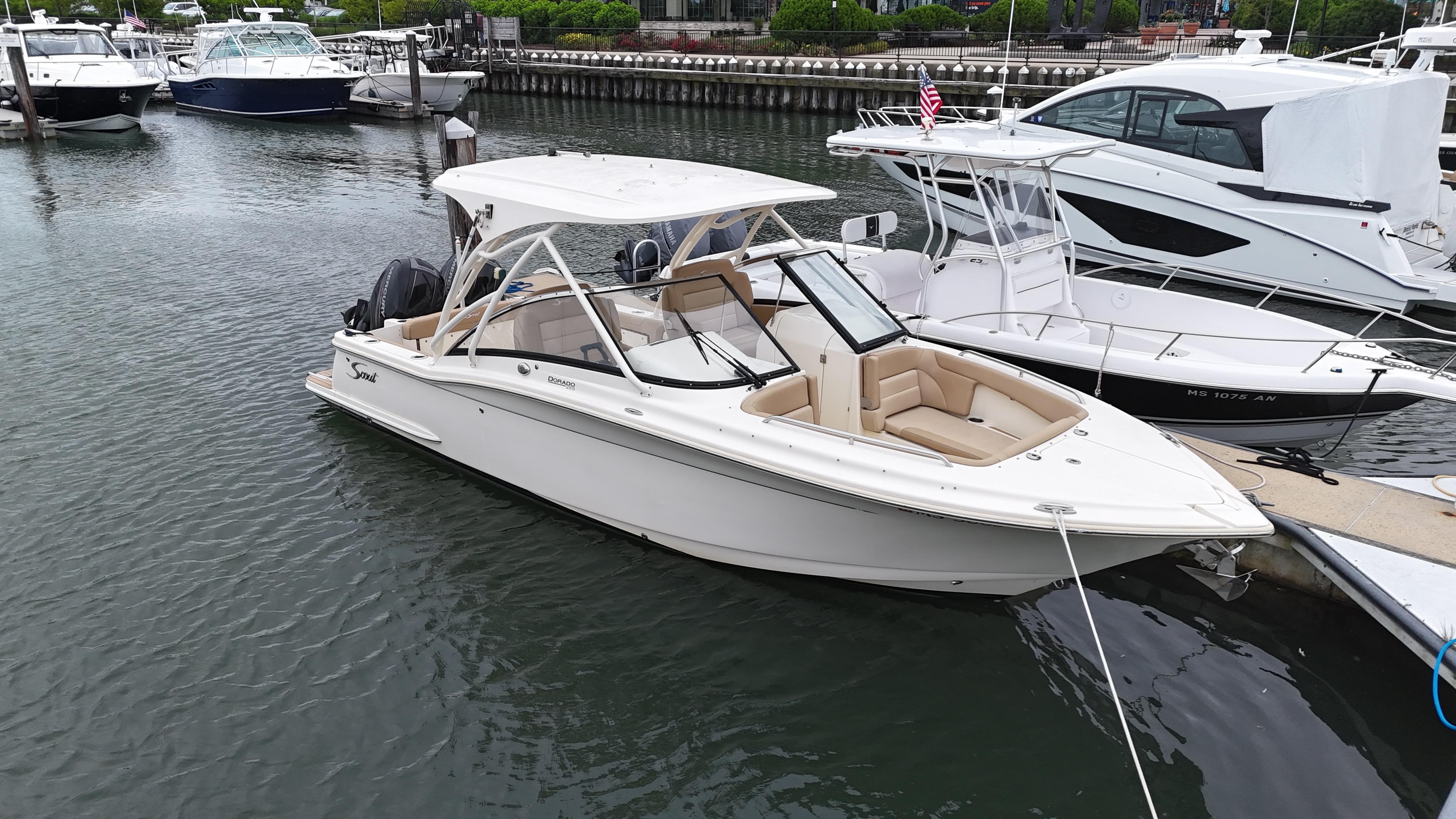 Scout 255 Dorado 2019 Scout 255 Dorado boat docked in a marina, surrounded by other vessels.