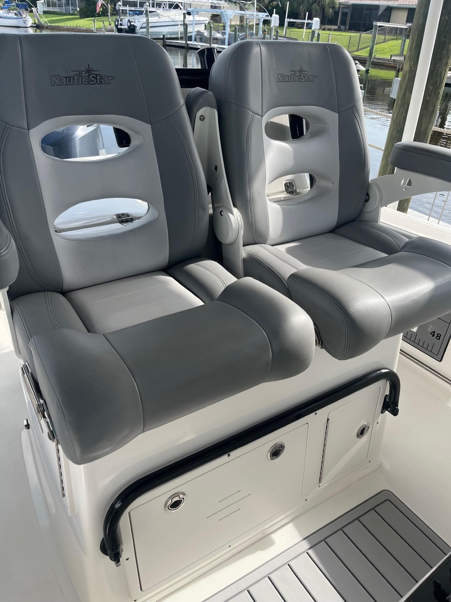 NauticStar 28 XS Offshore 2021 NauticStar 28 XS Offshore boat seats, gray leather, dual seating, docked.