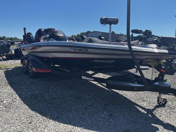 Triton 20 TRX MIDWAY 2022 Triton 20 TRX MIDWAY boat on a trailer in a gravel lot.