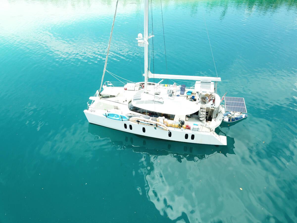 Tayana Isara 50 Aerial view of 2014 Tayana Isara 50 catamaran on calm blue water.