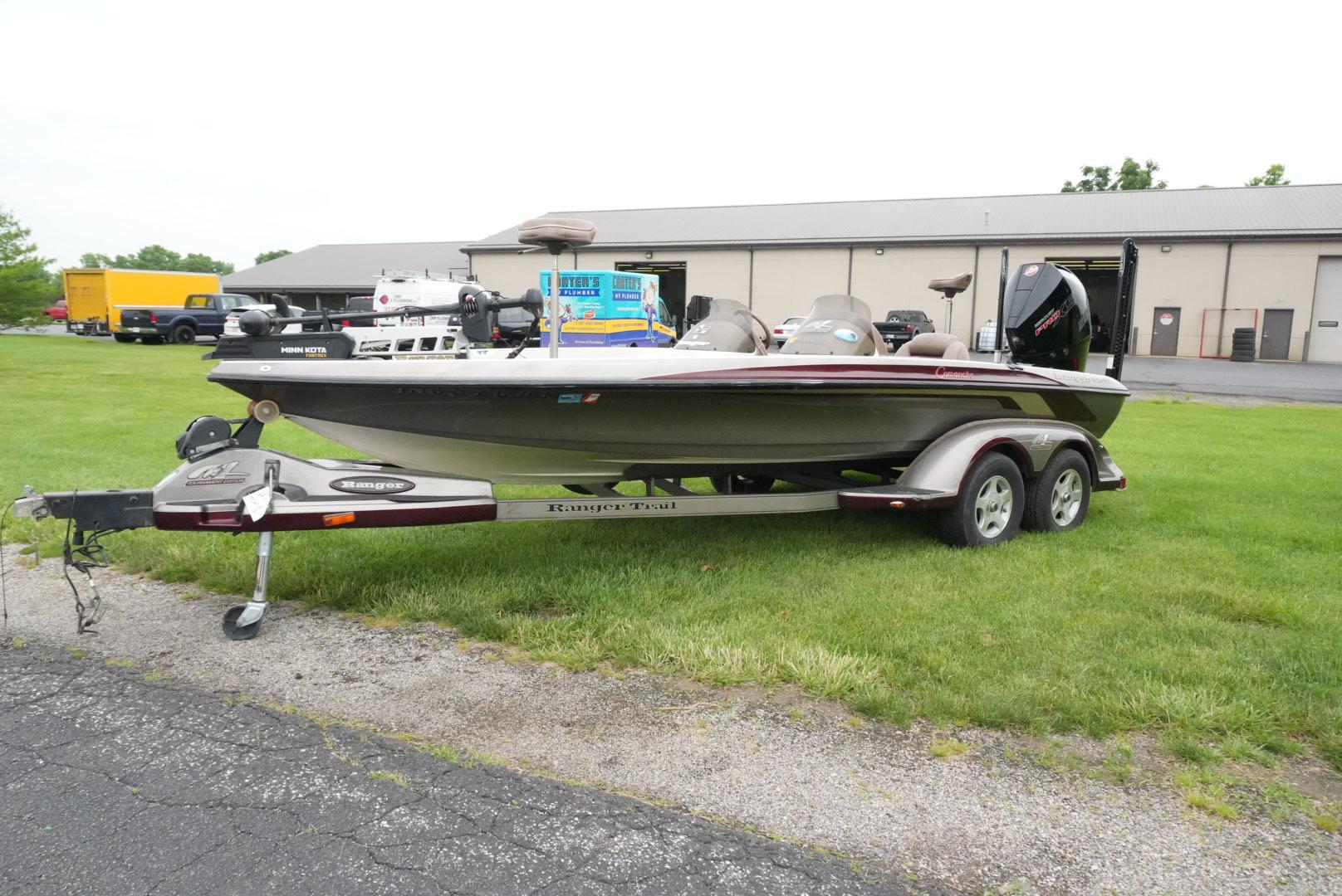 Ranger 520 Dvx 2000 Ranger 520 DVX boat on trailer, parked on grass near industrial building.