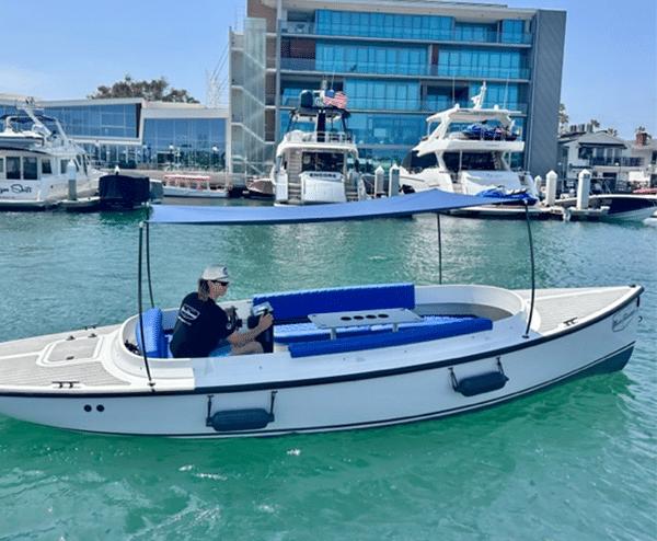 Vision Marine Technologies Fantail 217 2023 Vision Marine Technologies Fantail 217 boat cruising in a marina with yachts in the background.