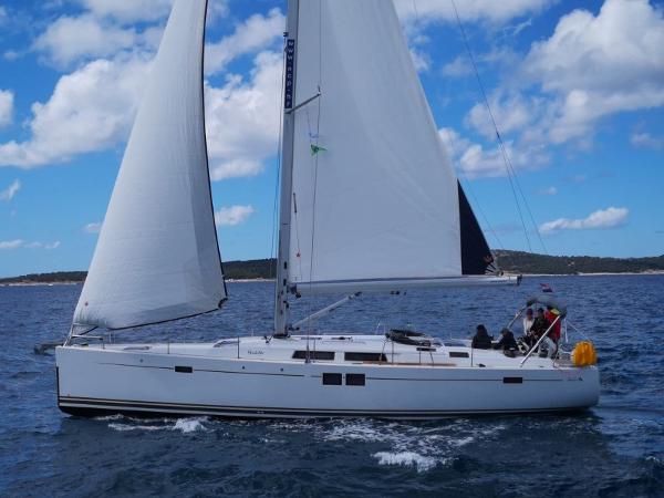 Hanse 505 2018 Hanse 505 sailboat navigating open waters under a clear blue sky.