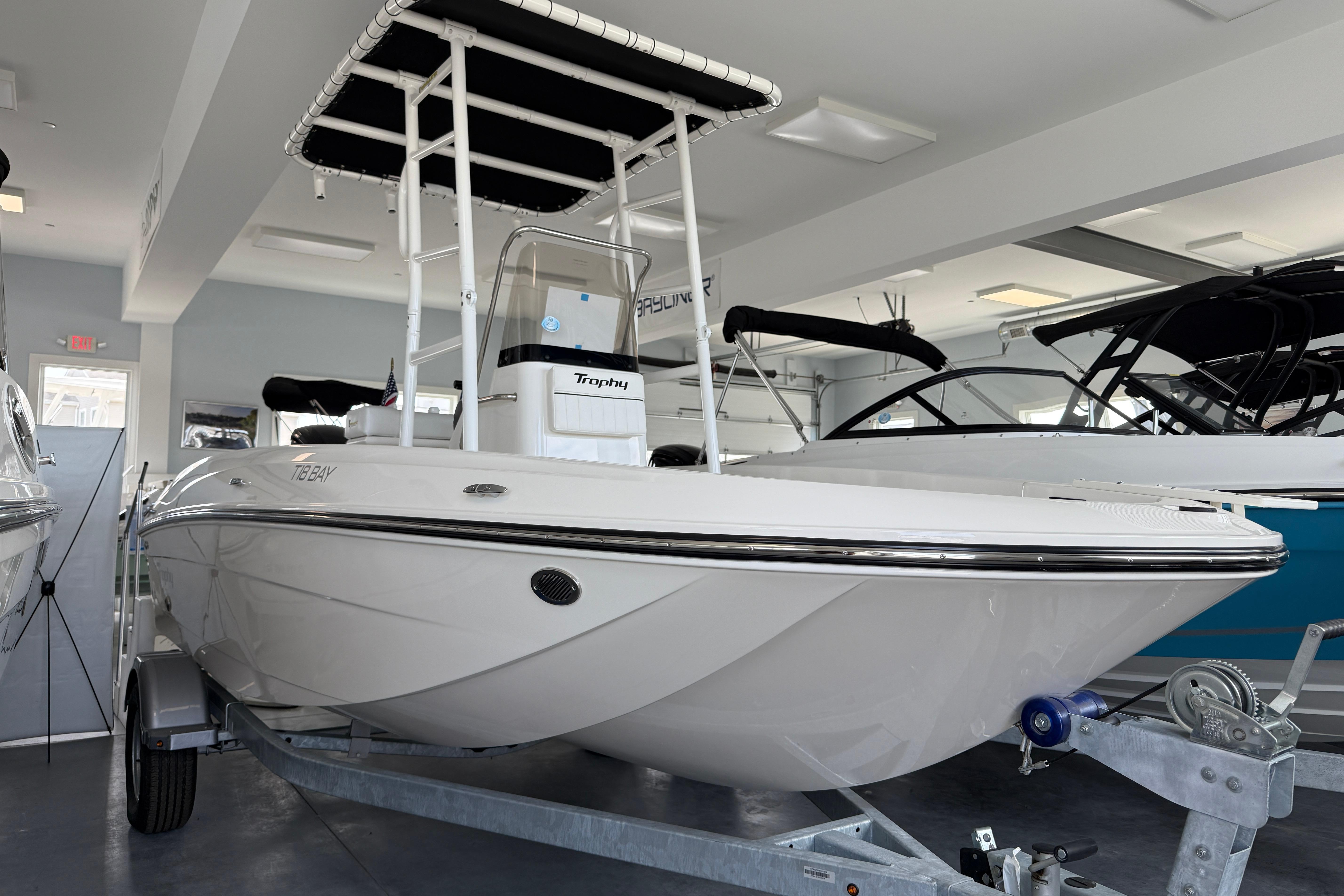 Bayliner Trophy T18 2025 Bayliner Trophy T18 boat displayed in showroom on trailer.