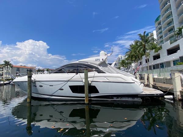 Sunseeker 48 Portofino XPS 2014 Sunseeker 48 Portofino XPS yacht docked at marina under clear blue sky.