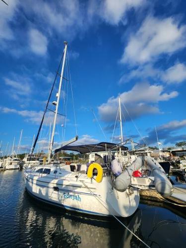 Catalina 387 Catalina 387 sailboat, 2007 model, docked in a marina under a vibrant blue sky.