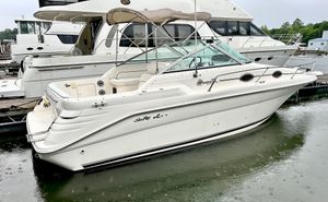Sea Ray 270 Sundancer 1999 Sea Ray 270 Sundancer boat docked at marina, side view.