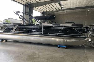 Starcraft CX 23 DL TT 2025 Starcraft CX 23 DL TT pontoon boat in a spacious indoor showroom.