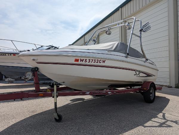 Glastron 175SX 2005 Glastron 175SX boat on a trailer in front of a storage facility.