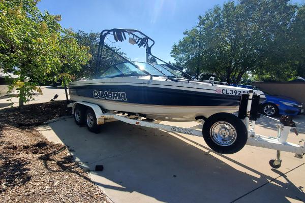 Calabria Sport Comp Xts 2000 Calabria Sport Comp XTS boat on trailer, parked outdoors.