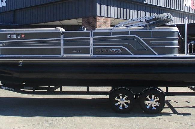 Ranger 200C 2018 Ranger 200C pontoon boat on trailer, parked outside a building.