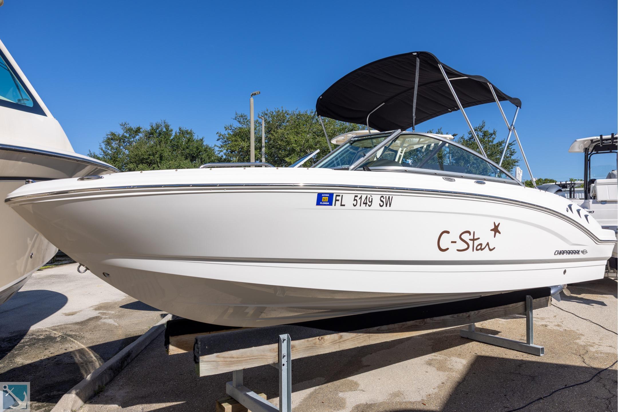 Chaparral 21 SSi OB 2020 Chaparral 21 SSi OB boat on display with canopy and sleek design.