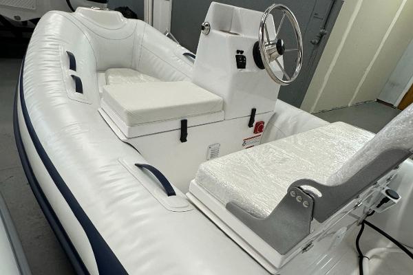 AB Inflatables Mares 10 VSX 2023 AB Inflatables Mares 10 VSX boat with white seating and steering console.