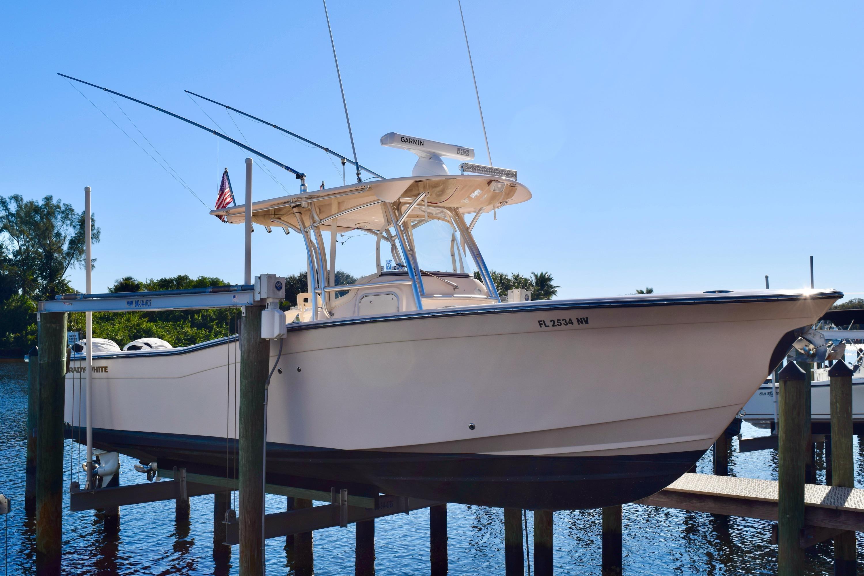 Grady-White Bimini 306 2006 Grady-White Bimini 306 boat docked on a lift, clear blue sky background.