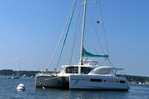 Leopard 48 2013 Leopard 48 catamaran anchored in calm waters under a clear blue sky.